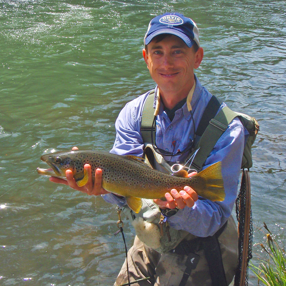 Guide Andrew Harris with a brown trout from the McCloud River