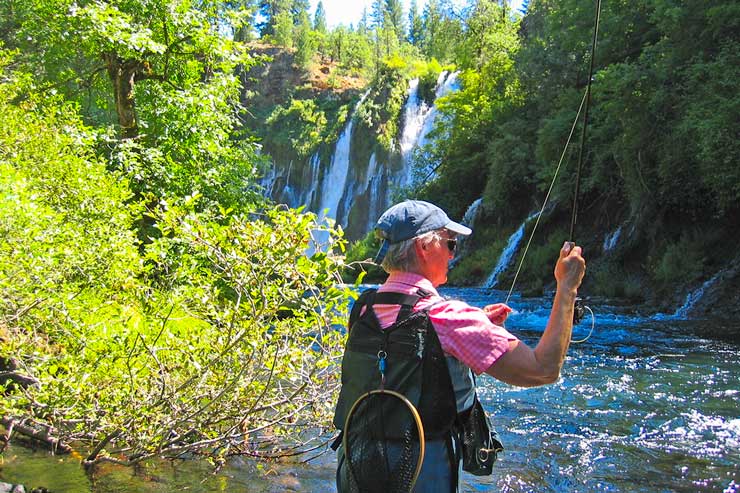 An angler casting a fly downstream from Burney Falls