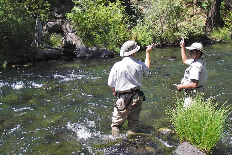 Guide Dax Messett helps his guest with the casting motion