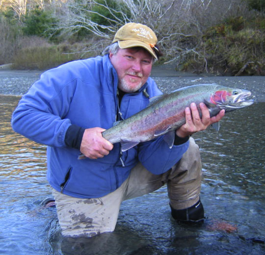 An angler with a steelhead from one of Oregon's coastal streams.