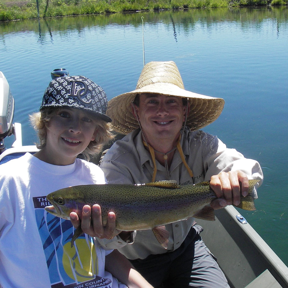 Guide Andrew Harris and guest with a rainbow trout from Fall River