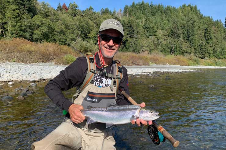 An angler with a wild steelhead on the Klamath