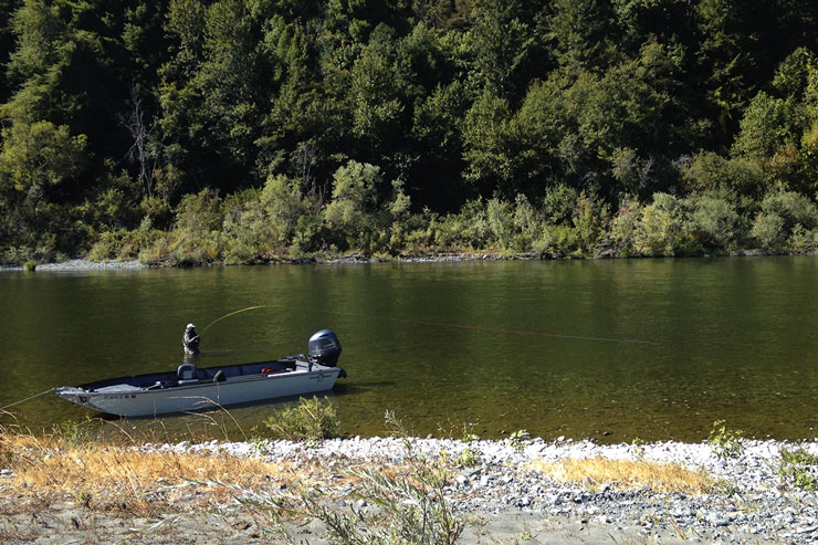 An angler hooked up in a long steelhead run