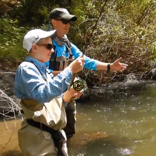 Guide Andrew Harris helps his guest land a fish