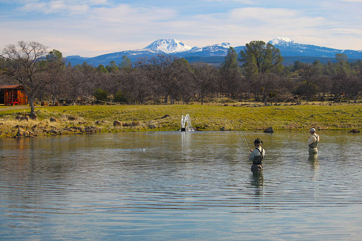 Two anglers fish the lower pond with Mt Lassen in the background.