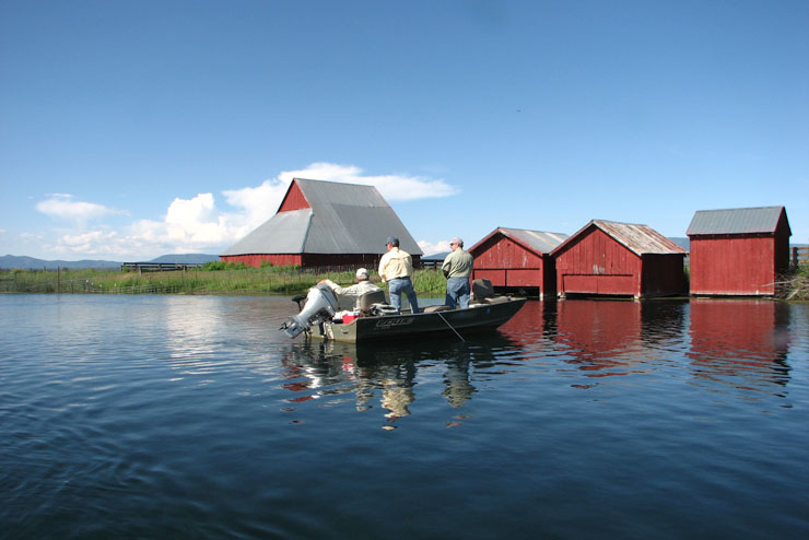 A guide fishing his clients near the Red Barns