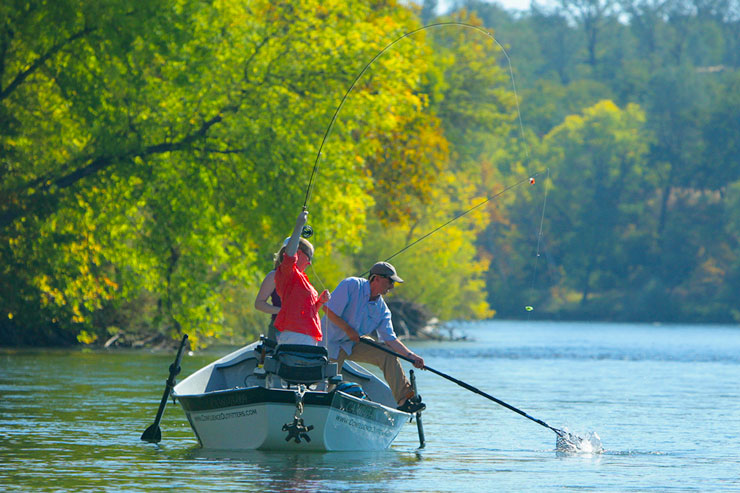 Guide Andrew Harris lands a Lower Sac rainbow