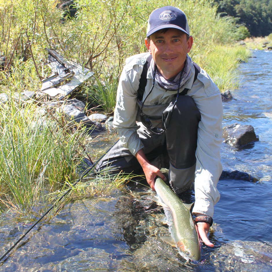 Guide Andrew Harris releasing a Trinity River steelhead