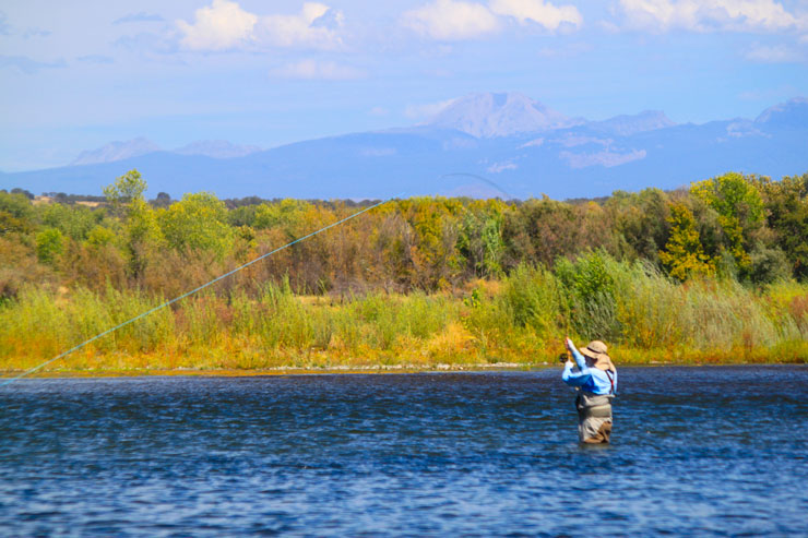 An angler hooked up with Mt Lassen in the background