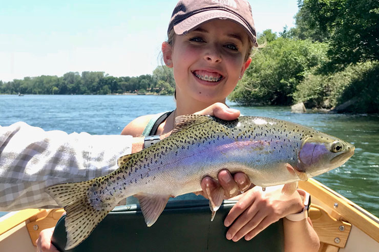 A young angler with a nice catch on a Lower Sac drift boat trip